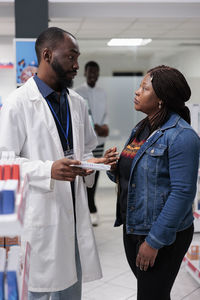 Portrait of female friends standing in laboratory