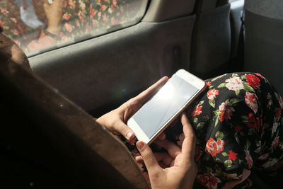 Close up of women use smart phone in a car