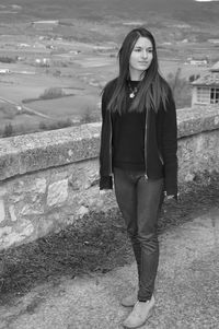 Full length of young woman looking away while standing on observation point