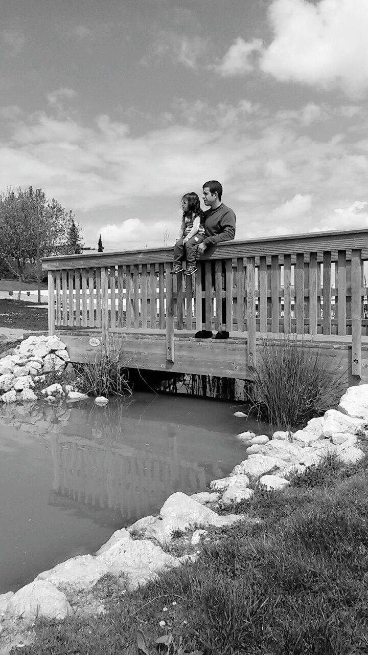 BUILT STRUCTURE BY RIVER AGAINST SKY