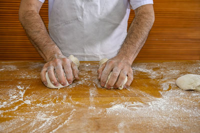 Midsection of man preparing food in kitchen