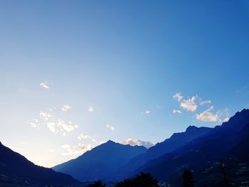 Scenic view of mountains against blue sky