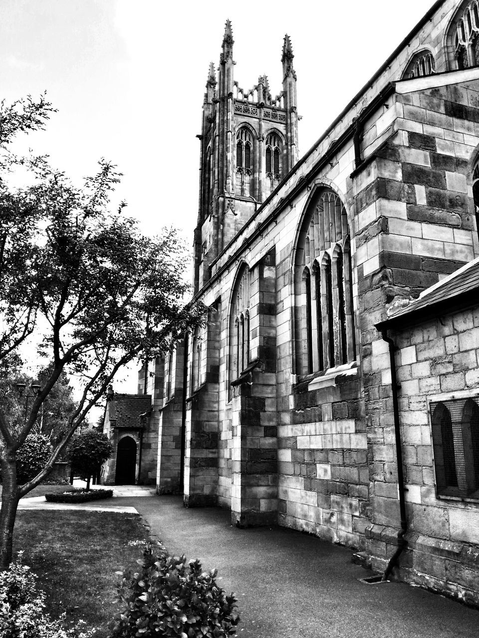 architecture, built structure, building exterior, low angle view, sky, history, church, clear sky, tree, facade, arch, building, old, day, religion, outdoors, window, place of worship, exterior, no people