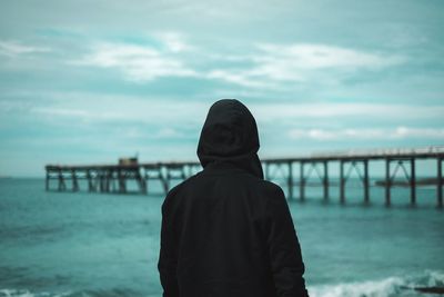 Rear view of man looking at sea