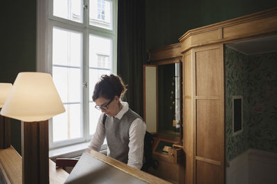 Female lawyer standing at desk in library