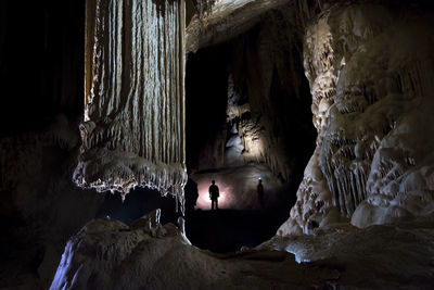 Silhouette man standing in cave