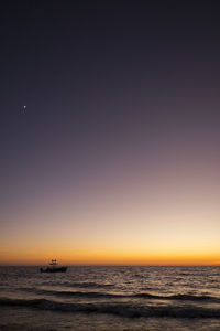 Scenic view of sea against clear sky during sunset