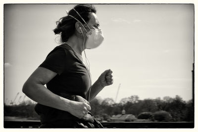 Side view of man playing against sky