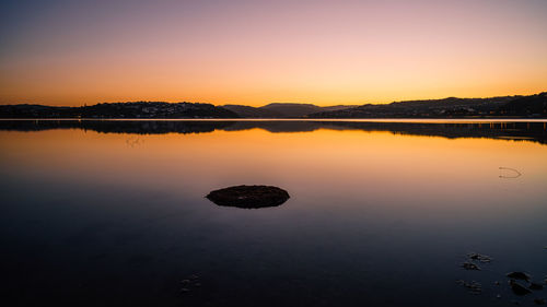 Scenic view of lake against sky during sunset