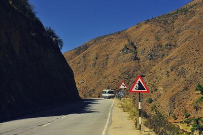 Road leading towards mountain against sky