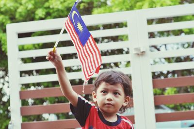 Boy holding malaysian flag