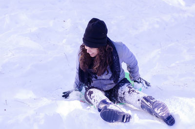 High angle view of woman enjoying in snow