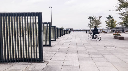 Man riding bicycle on footpath