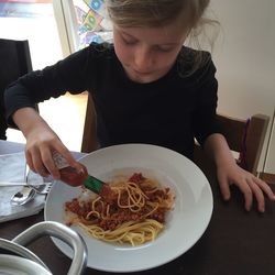 Woman eating food in plate