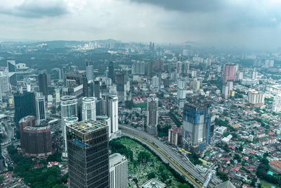 High angle view of modern buildings in city against sky