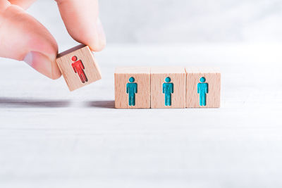 Close-up of hand holding painting on table