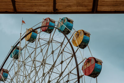 Low angle view of ferris wheel against sky