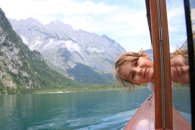 Portrait of girl in lake against mountains