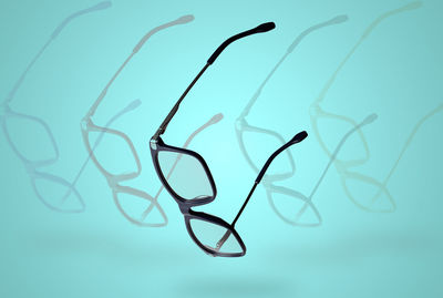 Close-up of eyeglasses against blue background