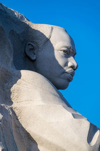 Low angle view of statue against clear blue sky