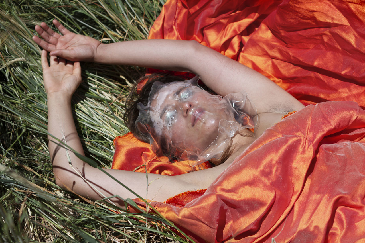 high angle view, one person, plant, lying down, real people, relaxation, child, day, hand, childhood, lifestyles, nature, human hand, indoors, women, food and drink, baby, food, orange color, innocence