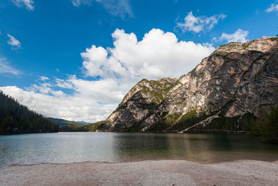 Scenic view of lake by mountains against sky