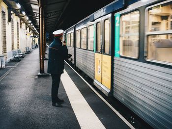 Man standing on railroad station platform