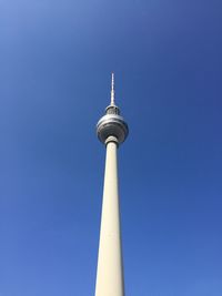 Low angle view of fernsehturm tower against clear blue sky