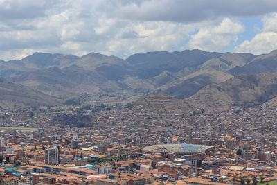 High angle view of townscape and mountains against sky