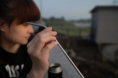 Close-up portrait of woman holding camera