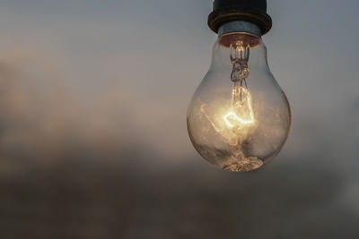 Low angle view of illuminated light bulb