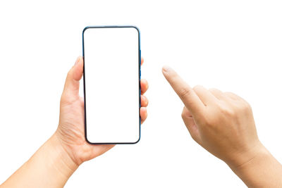 Midsection of person holding smart phone against white background