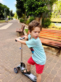 Portrait of boy standing on street