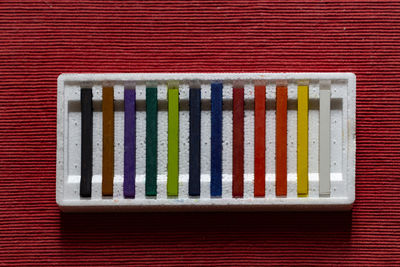 High angle view of multi colored pencils on shelf