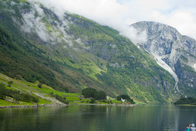 Scenic view of lake and mountains against sky