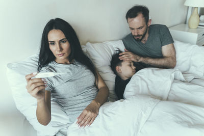 Young couple relaxing on bed at home