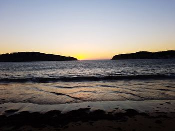 Scenic view of sea against clear sky during sunset