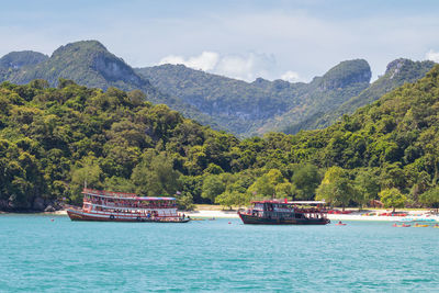 Scenic view of sea and mountains against sky