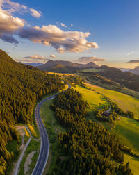 High angle view of road amidst trees against sky