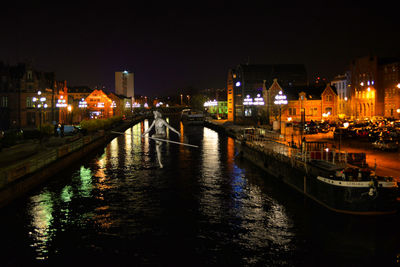 Boats in canal at night