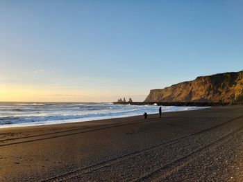 Scenic view of beach against clear sky