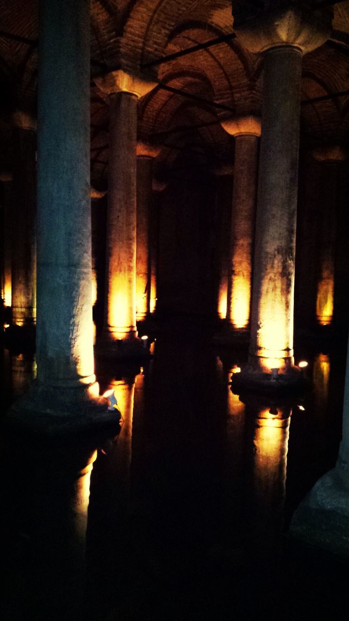 indoors, illuminated, architectural column, architecture, built structure, dark, light - natural phenomenon, night, column, history, lighting equipment, in a row, sunlight, interior, glowing, no people, silhouette, lit, spirituality, religion