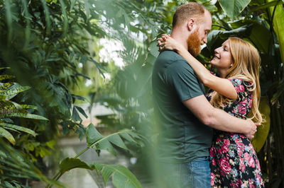 Young couple kissing plants