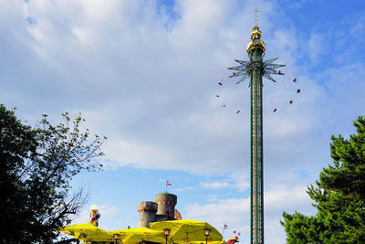 Low angle view of carousel against sky