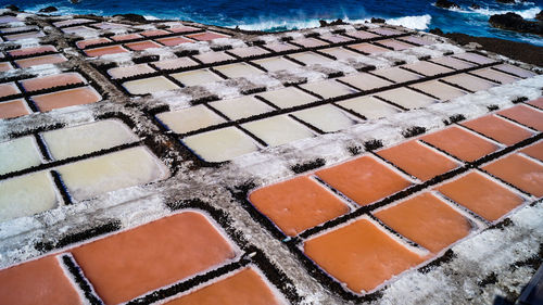 High angle view of salt flat sea salk farm water fields multicolour texture background 