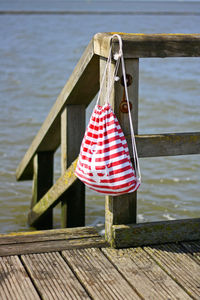 Wooden jetty and a backpack on pier at the sea