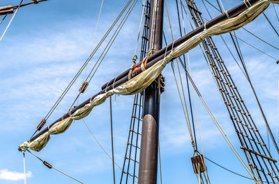 Replica of nao victoria ship in seville, andalusia, spain. detail of the mast. blue sky.