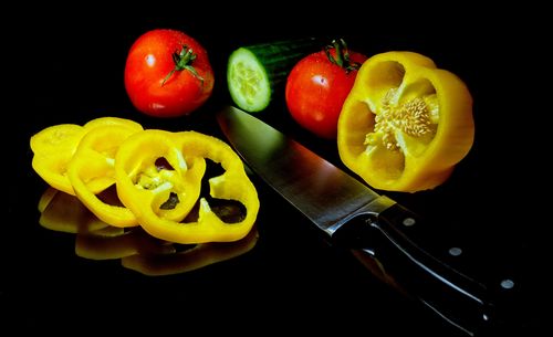 High angle view of chopped fruits against black background