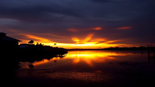 Scenic view of sea against dramatic sky during sunset