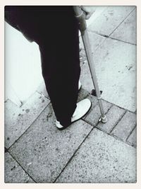 Low section of man standing on tiled floor